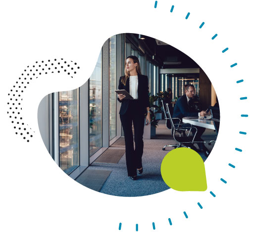 Photo of woman walking in a office looking out the window